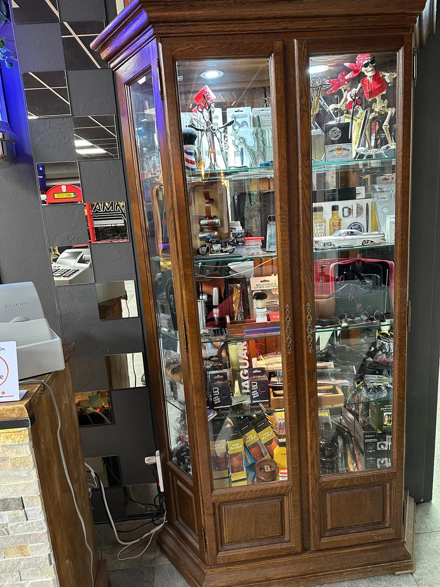 The wooden display cabinet with hair and shaving products at Amro Style